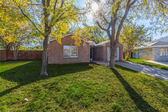 ranch-style home with a front lawn