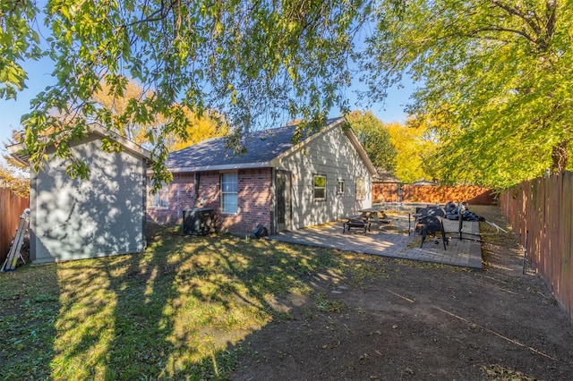 exterior space with a yard, a patio area, and a storage unit