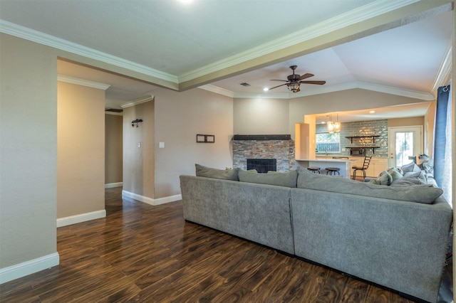 living room with crown molding, lofted ceiling, dark hardwood / wood-style floors, and a fireplace