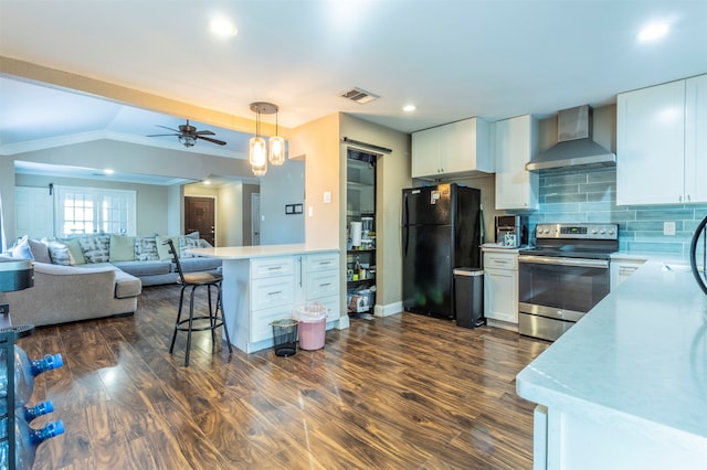 kitchen featuring white cabinetry, stainless steel electric range oven, dark wood-type flooring, wall chimney range hood, and black refrigerator