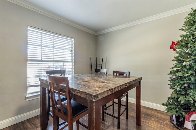 dining area featuring dark hardwood / wood-style floors and crown molding