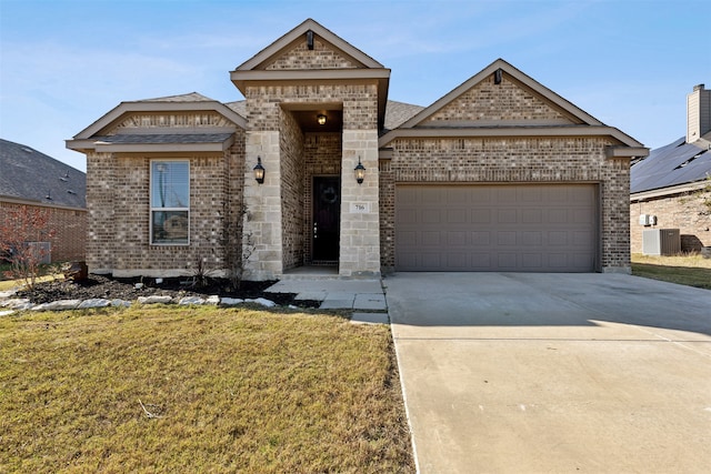 view of front of house featuring a front yard, a garage, and central AC unit