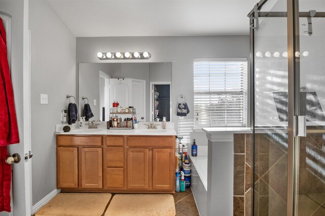 bathroom featuring tile patterned flooring, vanity, and a shower with shower door