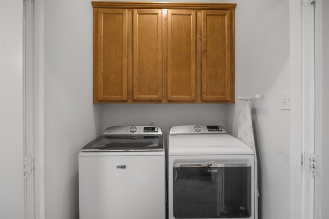 laundry area with cabinets and washer and dryer