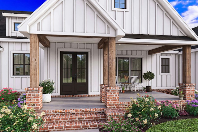 entrance to property with a porch and french doors