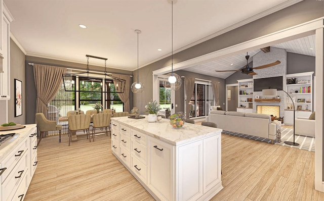 kitchen featuring white cabinetry, pendant lighting, vaulted ceiling, and light wood-type flooring