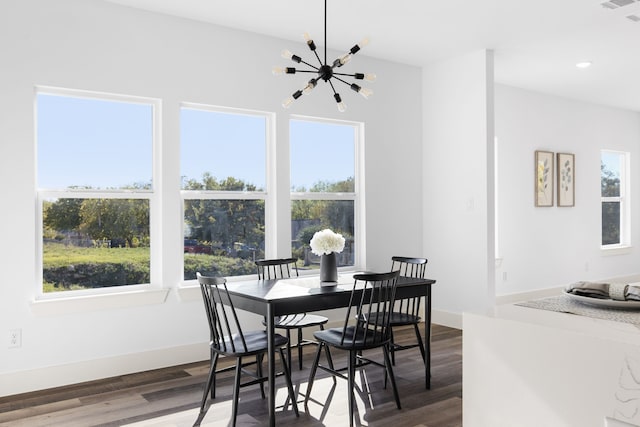 dining space featuring a wealth of natural light, a chandelier, and dark hardwood / wood-style floors