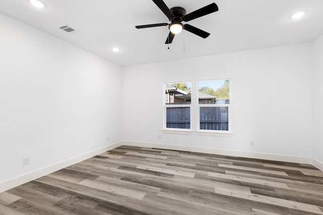 unfurnished room with ceiling fan and hardwood / wood-style flooring