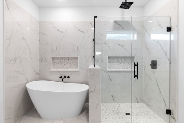 bathroom featuring plus walk in shower and tile walls