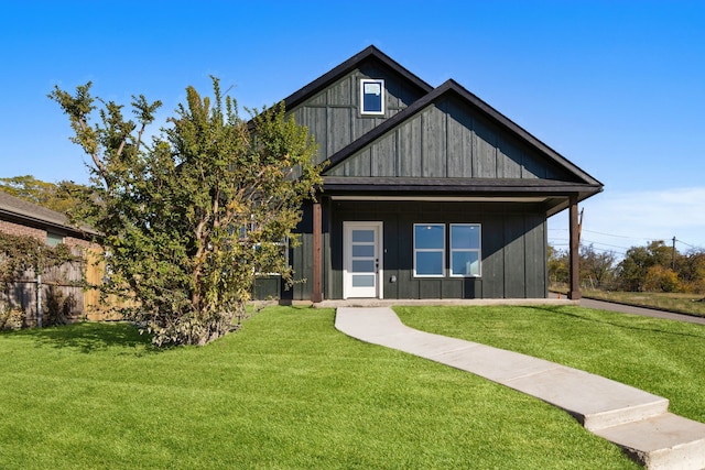 rear view of property with a yard