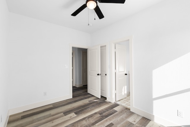 empty room featuring ceiling fan and dark hardwood / wood-style flooring