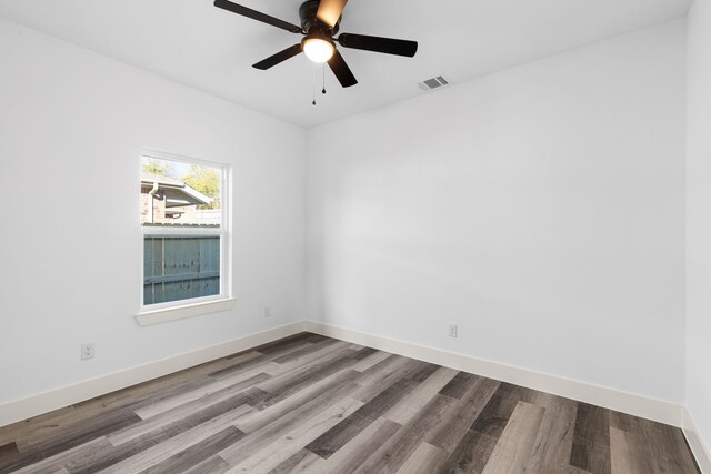 empty room featuring hardwood / wood-style flooring and ceiling fan