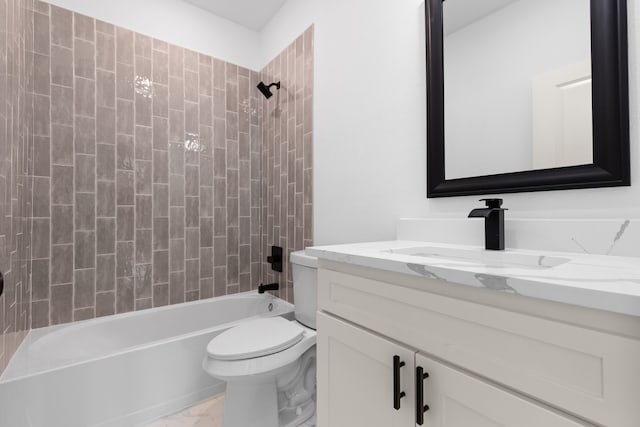 full bathroom featuring vanity, tiled shower / bath combo, and toilet