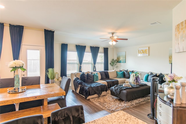 living room featuring hardwood / wood-style flooring, ceiling fan, and a healthy amount of sunlight