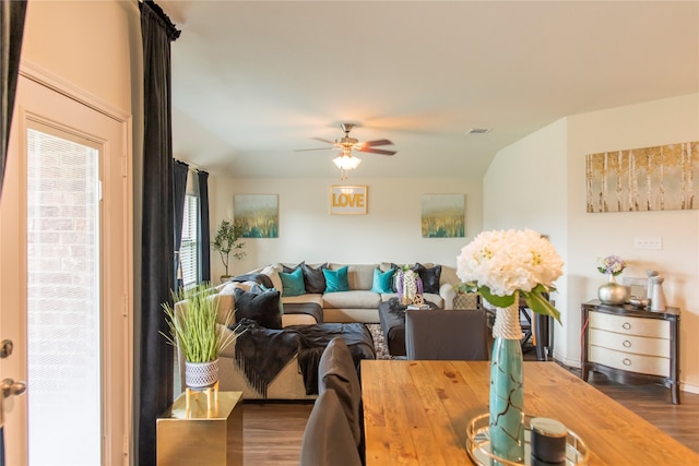 living room with lofted ceiling, ceiling fan, and dark wood-type flooring