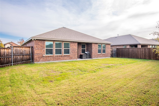 back of property featuring a yard