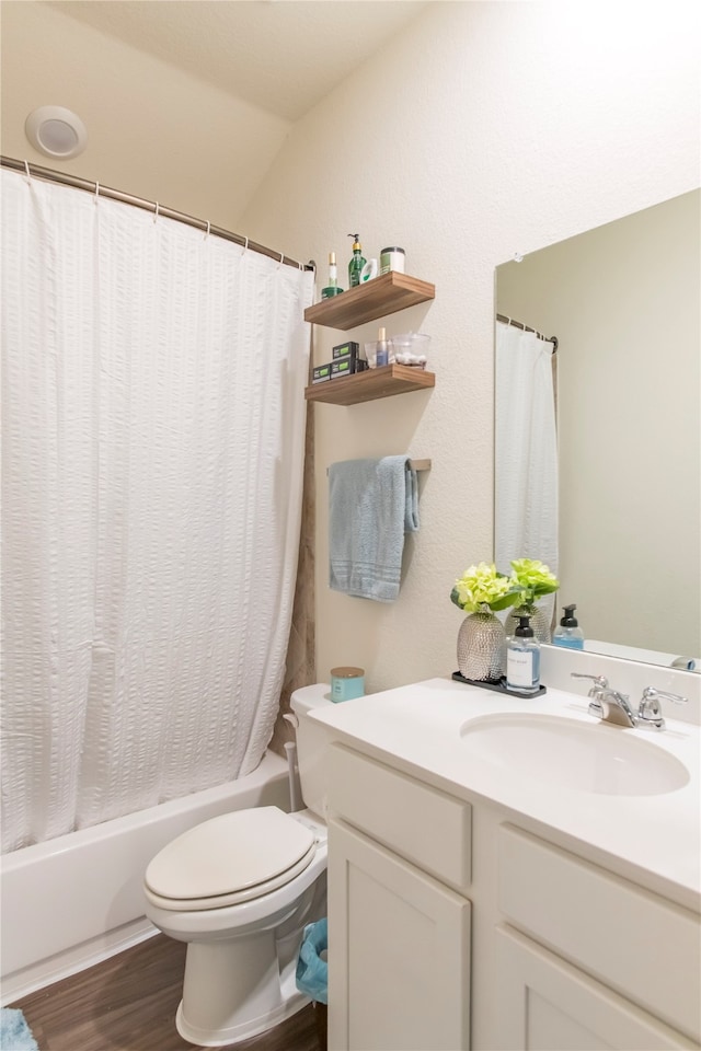 full bathroom featuring hardwood / wood-style floors, vanity, vaulted ceiling, toilet, and shower / tub combo