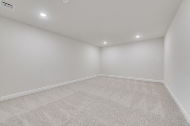 spare room featuring light carpet