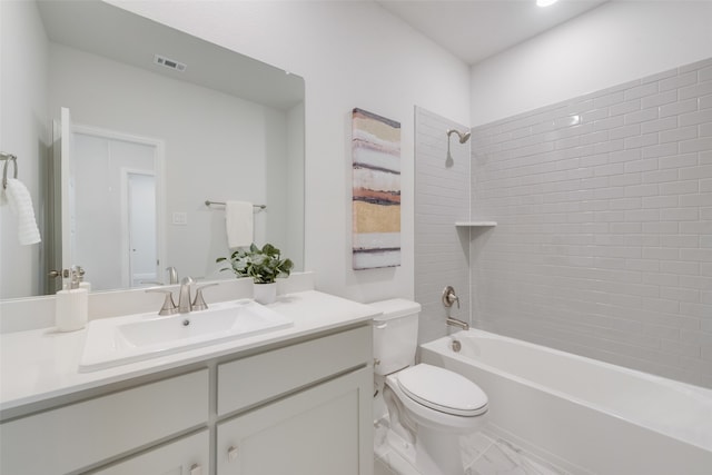 full bathroom with vanity, tiled shower / bath combo, and toilet