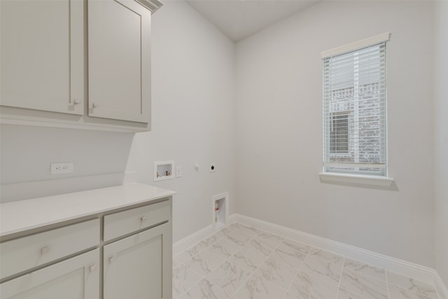 laundry room featuring electric dryer hookup, cabinets, and washer hookup