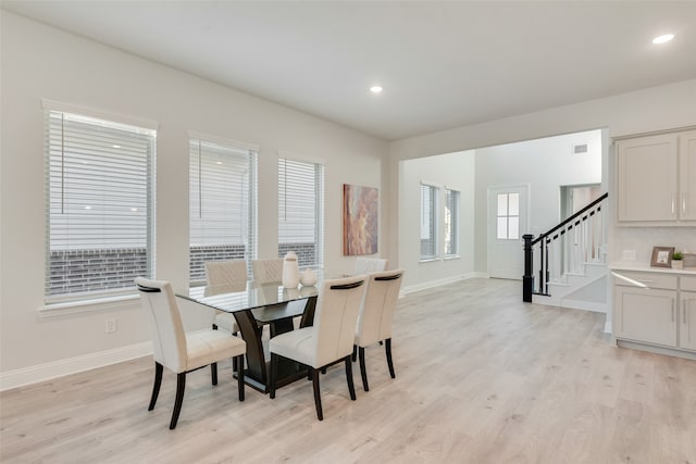 dining space with light hardwood / wood-style flooring