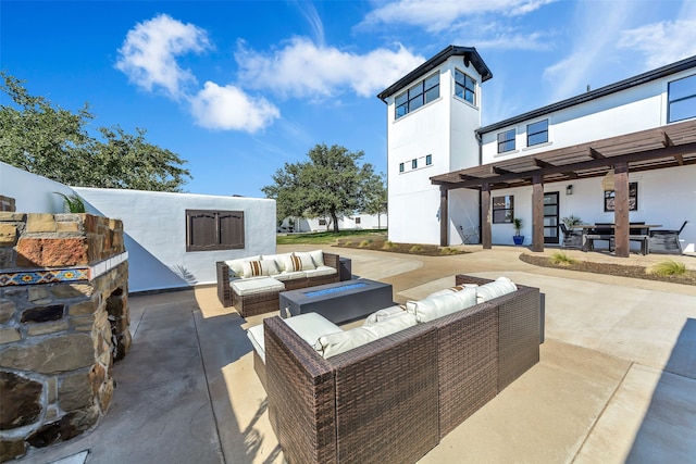 view of patio featuring a pergola and an outdoor living space with a fire pit