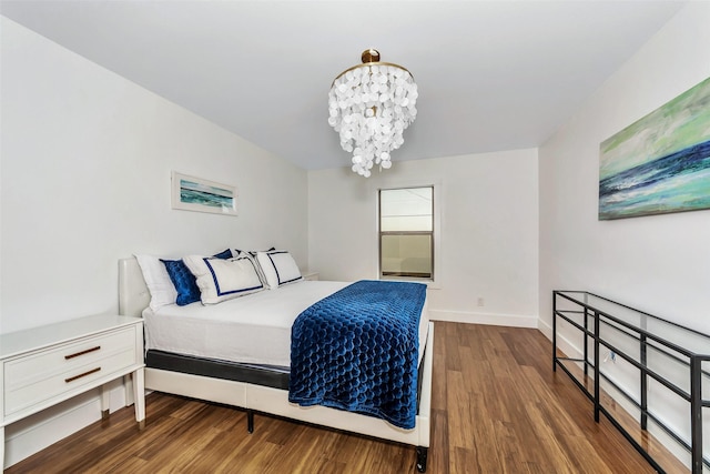 bedroom with dark wood-type flooring and a notable chandelier