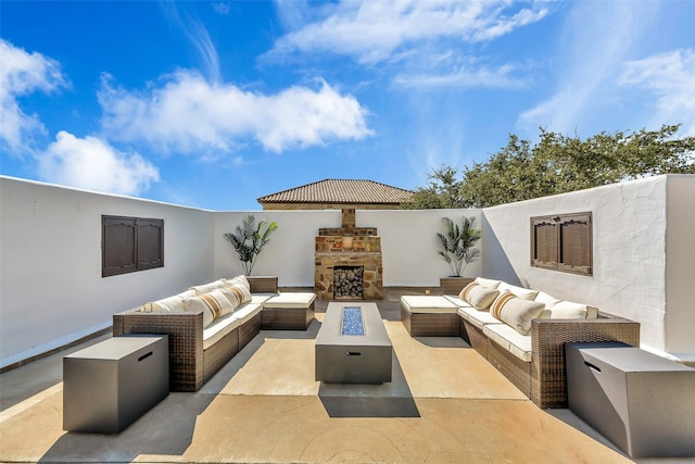 view of patio / terrace with an outdoor living space with a fireplace