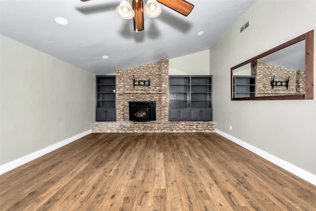 unfurnished living room featuring ceiling fan, built in features, hardwood / wood-style floors, and lofted ceiling