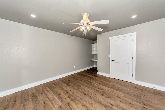 spare room featuring ceiling fan and dark wood-type flooring