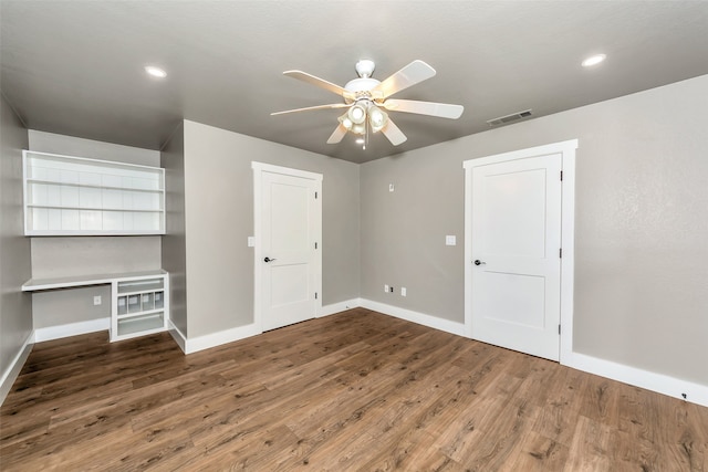 unfurnished bedroom featuring ceiling fan and dark hardwood / wood-style flooring