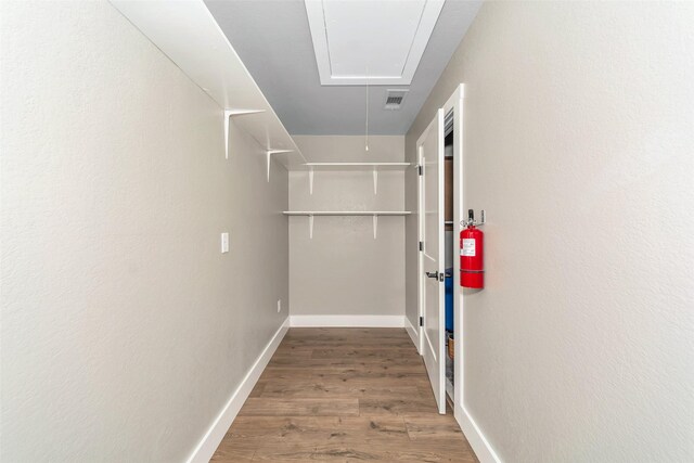 spacious closet featuring hardwood / wood-style flooring