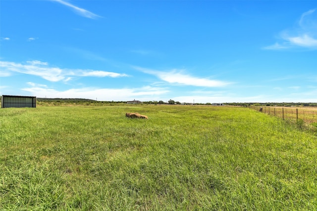 view of yard with a rural view