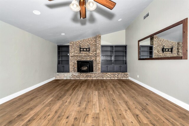 unfurnished living room featuring built in shelves, ceiling fan, lofted ceiling, and hardwood / wood-style floors