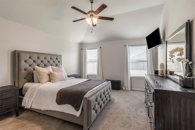 bedroom with light colored carpet, ceiling fan, and lofted ceiling