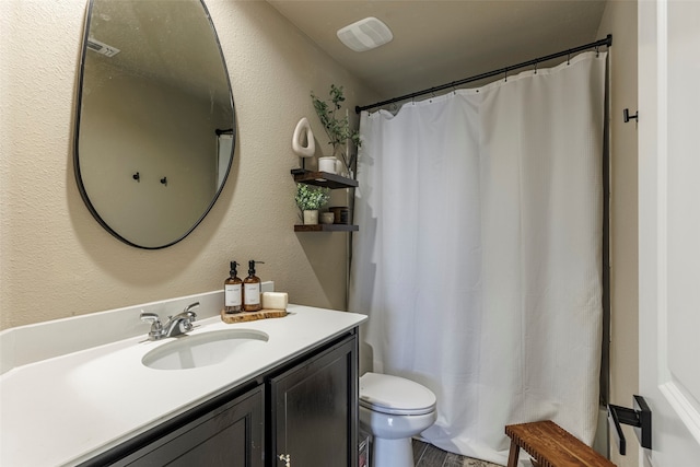 bathroom featuring vanity and toilet