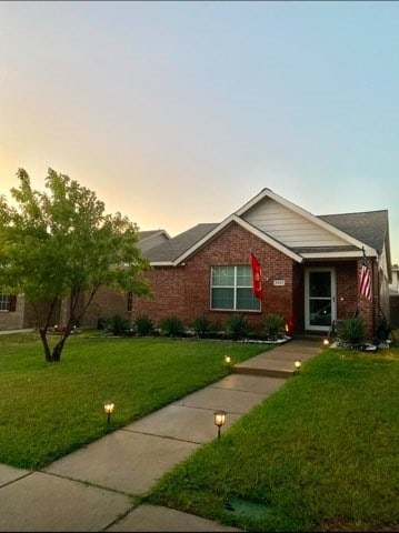 ranch-style home with a lawn