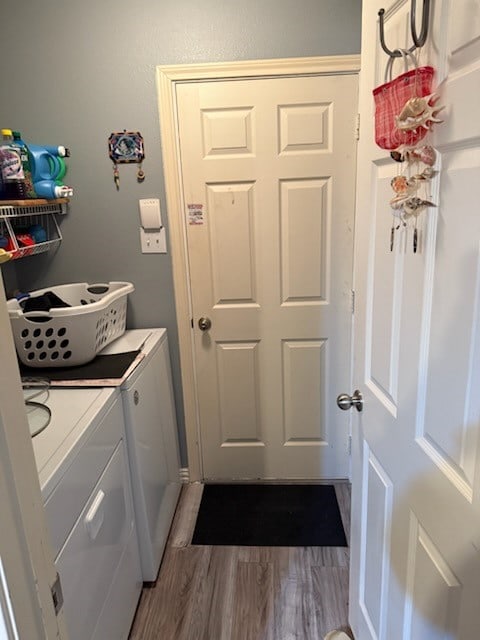 washroom featuring separate washer and dryer and wood-type flooring