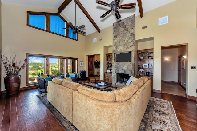 living room featuring dark hardwood / wood-style floors, beam ceiling, a fireplace, and high vaulted ceiling