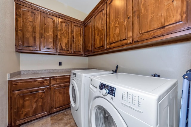 washroom featuring cabinets and washing machine and dryer