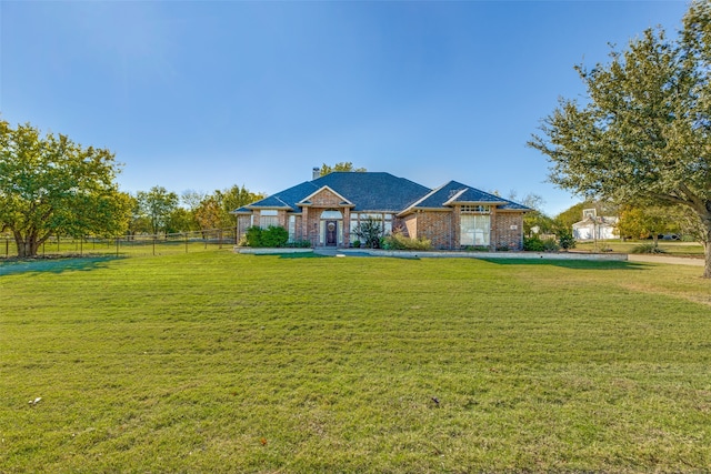 ranch-style home featuring a front yard