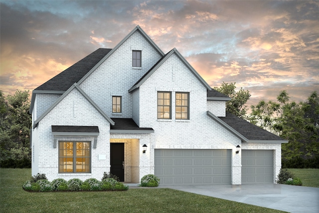 view of front of house with a yard and a garage