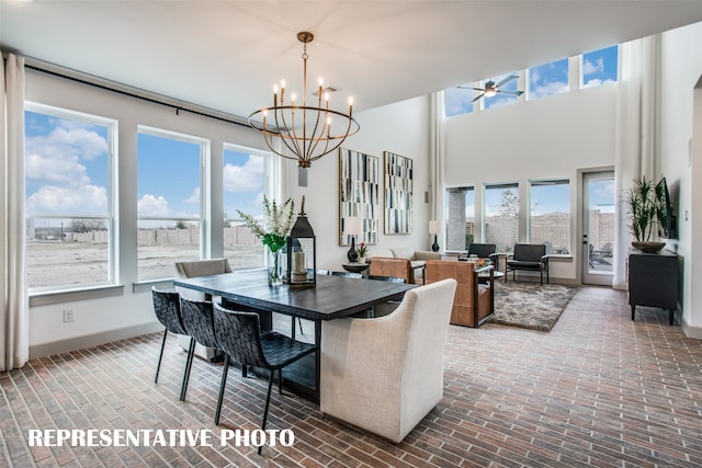 dining area featuring ceiling fan with notable chandelier