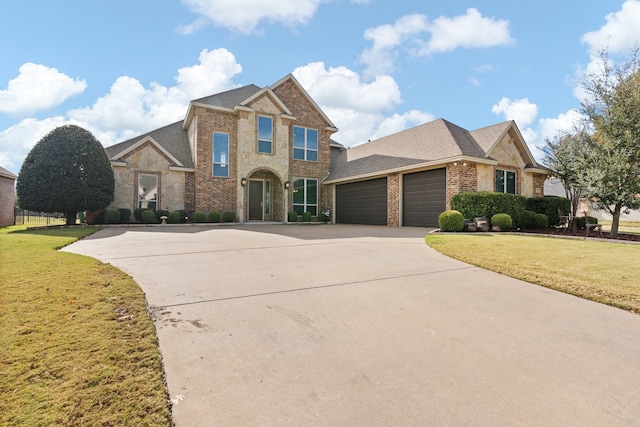 view of front of property featuring a garage and a front yard