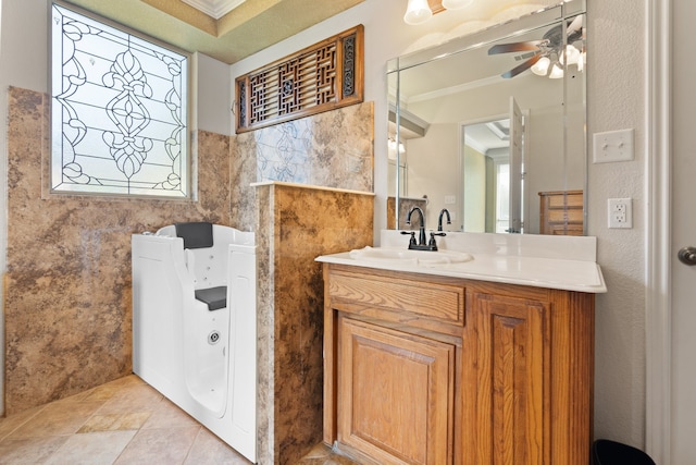 bathroom featuring ceiling fan, vanity, tile walls, and ornamental molding