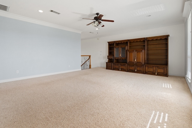 unfurnished living room with crown molding, carpet floors, and ceiling fan