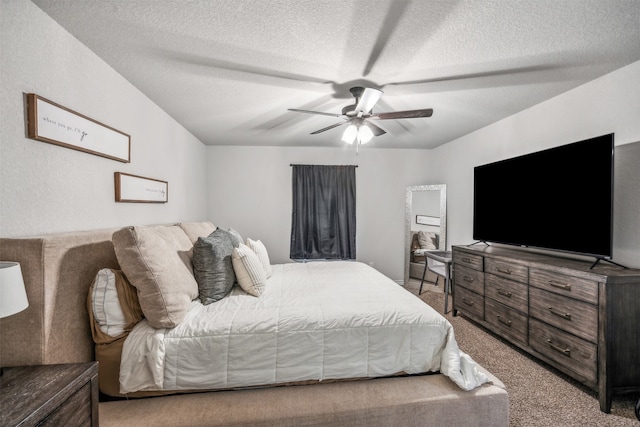 carpeted bedroom with ceiling fan and a textured ceiling