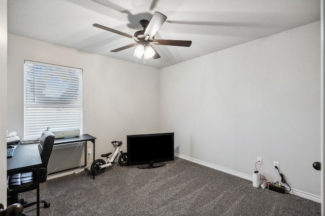 home office featuring ceiling fan and dark carpet