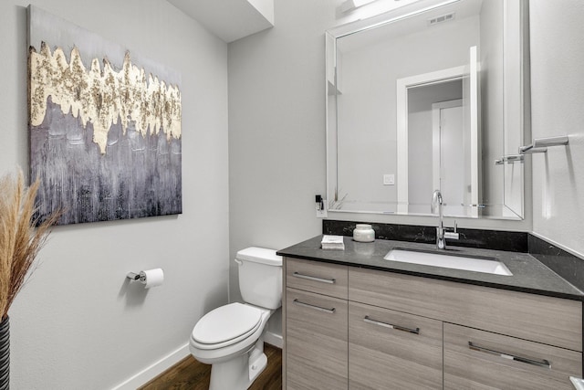 bathroom featuring hardwood / wood-style flooring, vanity, and toilet