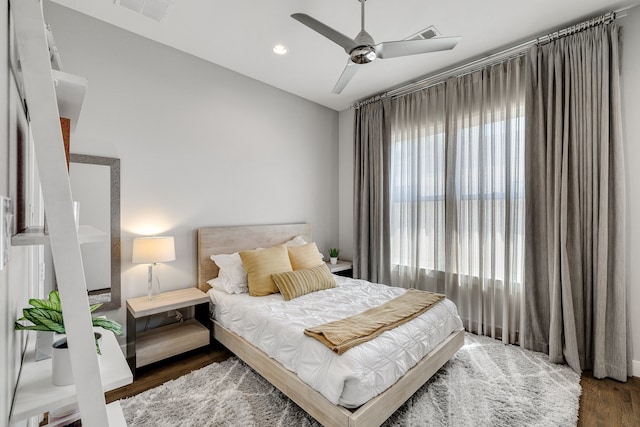 bedroom with ceiling fan and dark hardwood / wood-style flooring